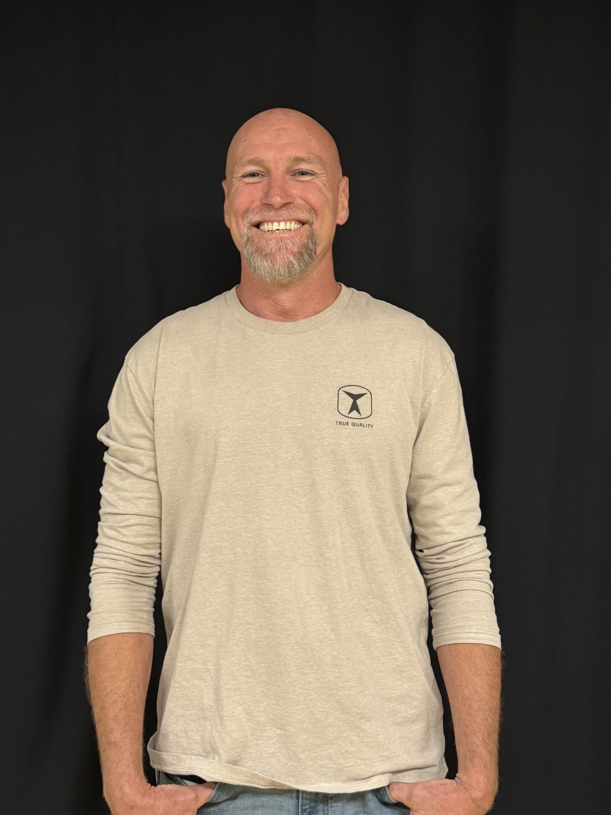 Jerry Bird, Handyman, Painter, and Concrete Specialist at True Quality Construction, smiling in a branded company shirt.